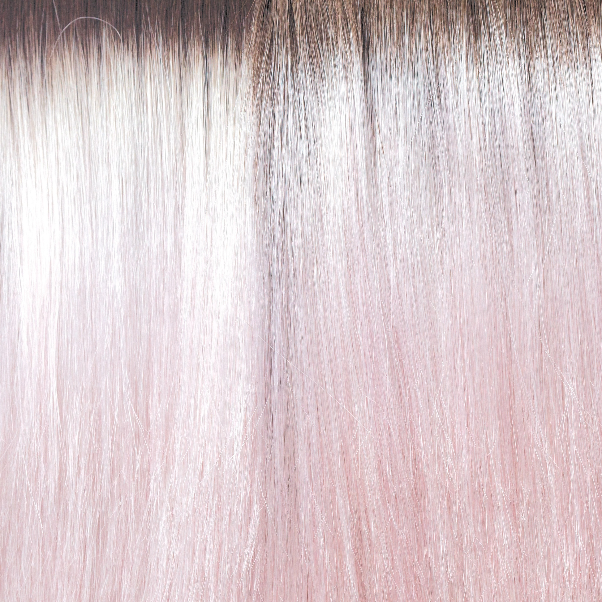 Bubblegum-R  -  A stunning silver, greyish pink with a slight bubble gum blond tone throughout the mid lengths and ends. This grows from an icy brown regrowth root making the piece look extremely realistic, with a pink water color toner Bubble Gum-R is so on trend.