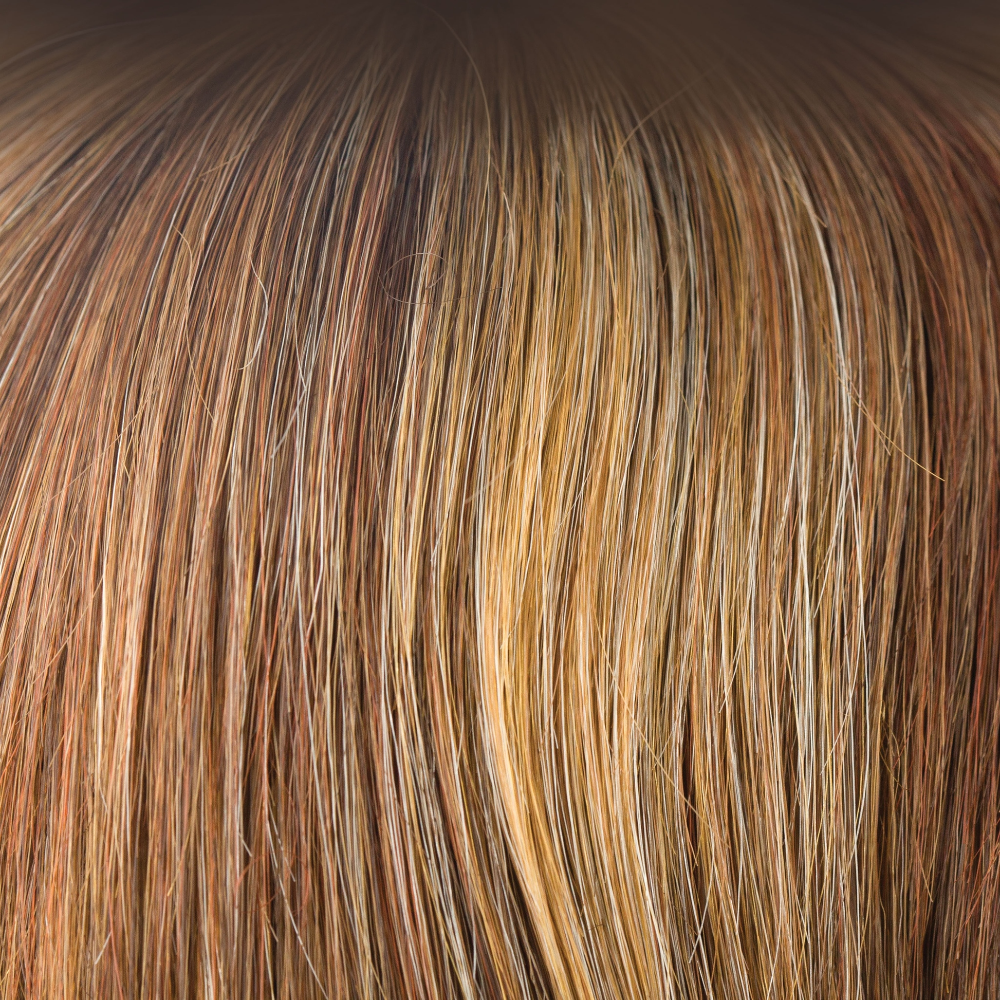 Copper Glaze-R  -  This rooted version of Copper Glaze has a regrowth of dark to medium amber brown and has honey gold blond highlights, scattering through to a medium copper brown. A much loved autumnal shade, this is both flattering and warm.