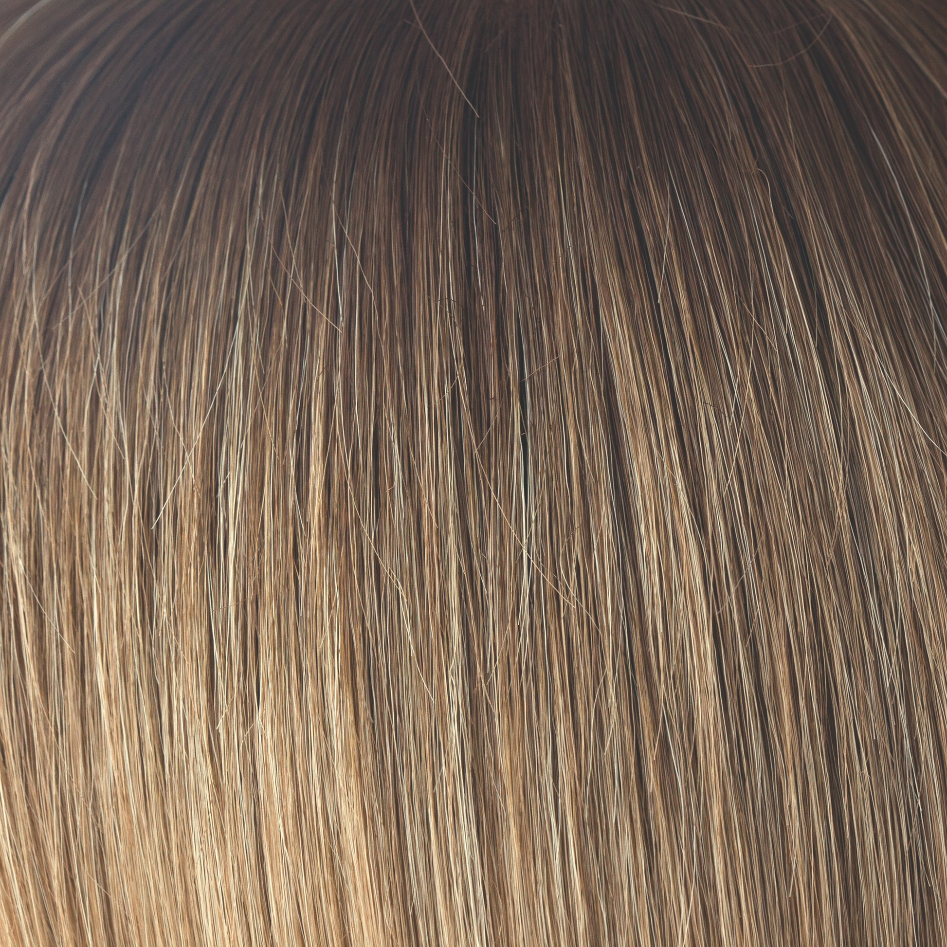 Macadamia-LR  -  The warm rich ombre of the macadamia brown roots blend through into soft, golden blond and walnut cream slices. With a luxury, velvet finish, Macadamia-LR looks great in long and mid length styles.