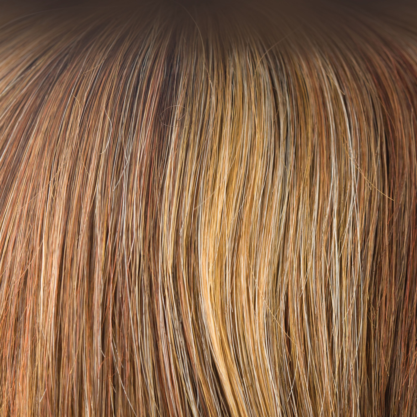 Copper Glaze  -  Has honey gold blond highlights scattering through a medium copper brown base. A much loved autumnal shade. This is flattering and warm. It is a great choice if you like a highlighted red copper.