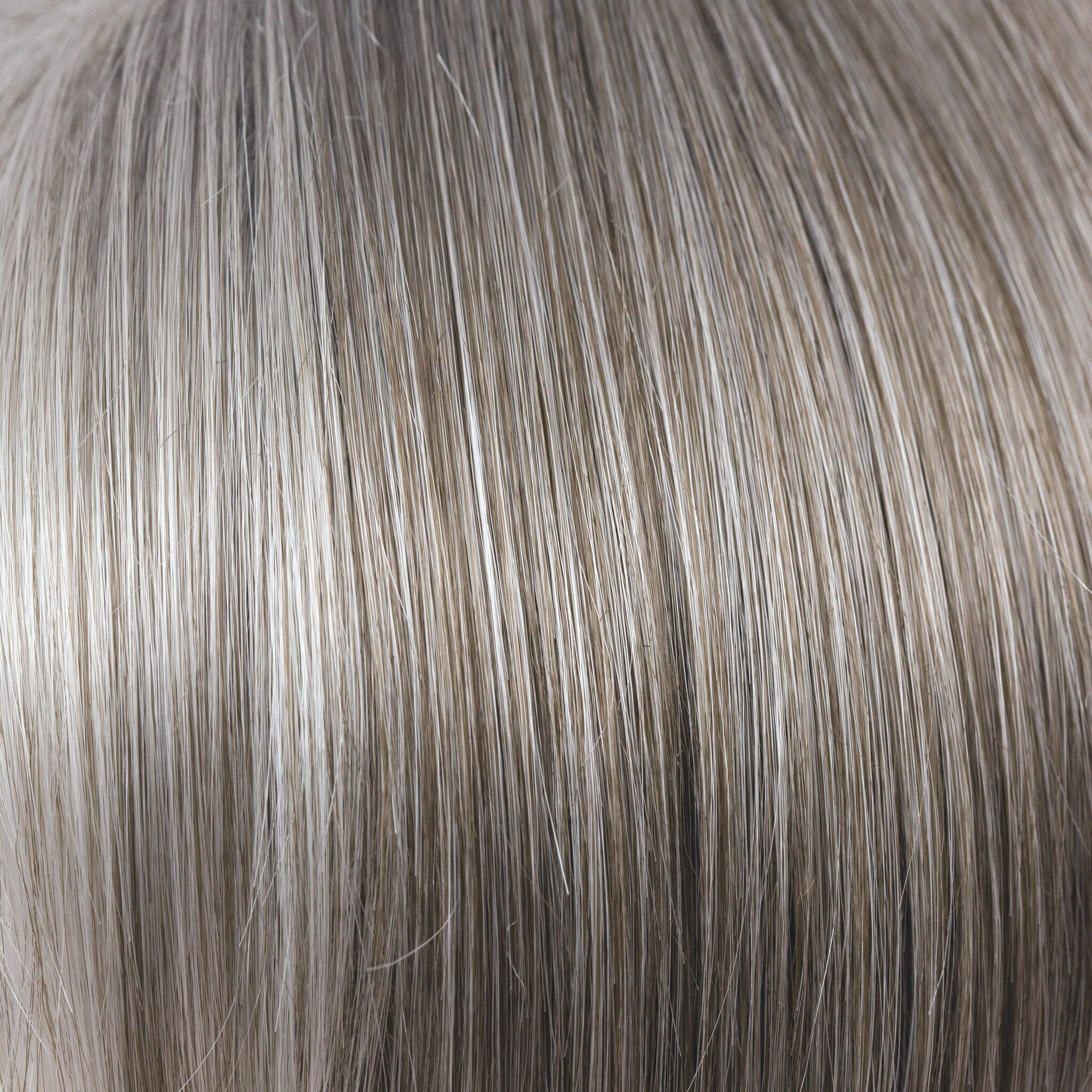 NM Sandy Silver  -  This gray tone is a warm, medium brown base with a mix of silvery white highlights. The color gradually goes from lighter at front to darker at nape. This color is perfect for those that love a gray color mixed with brown for a modern look!